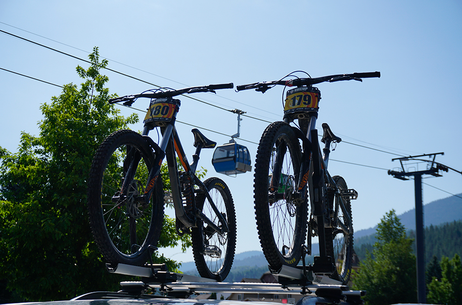 Bikes on top of a car with a gondola in the background