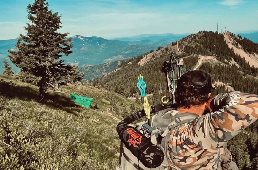 Man shooting a bow and arrow at the Silver Mountain Shootout